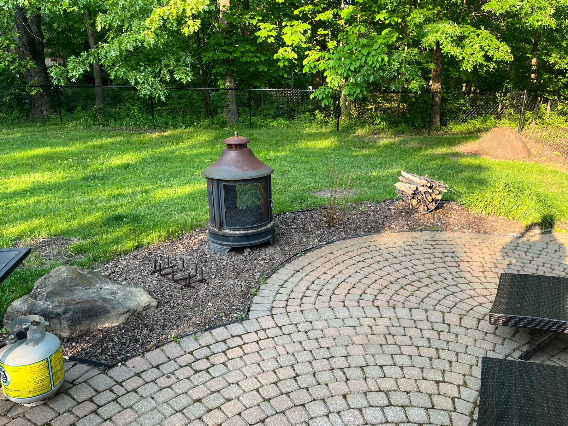 Beautifully landscaped backyard with paver patio and retaining wall